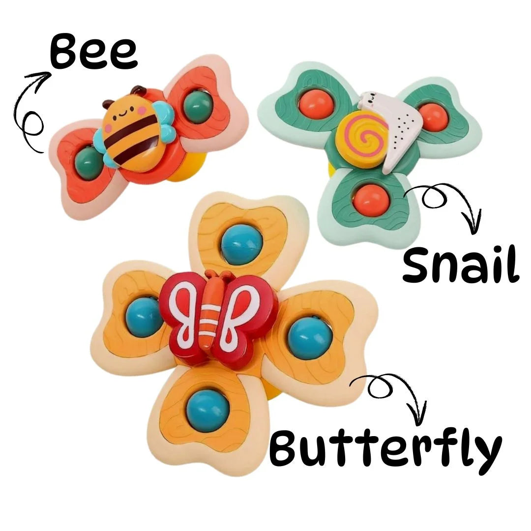 Set of three colorful baby spinning suction toys.