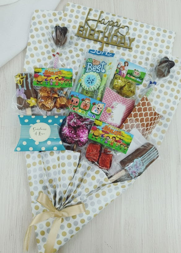 Gift basket with toys and snacks on a white surface