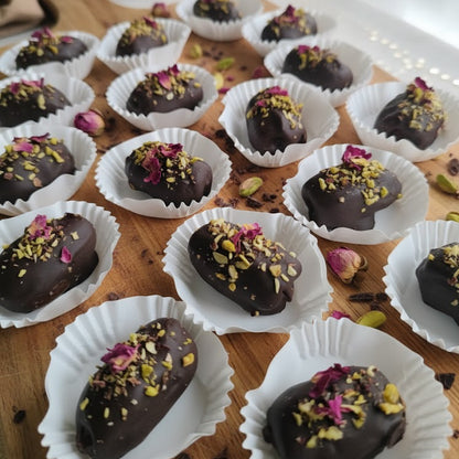 Chocolate truffles with toppings on a wooden surface