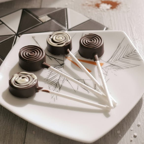 Chocolate candies on a decorative plate with geometric patterns